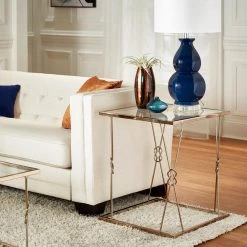 Champagne Gold Finish With Reef Knot Frame And Glass Top End Table by HomeSullivan